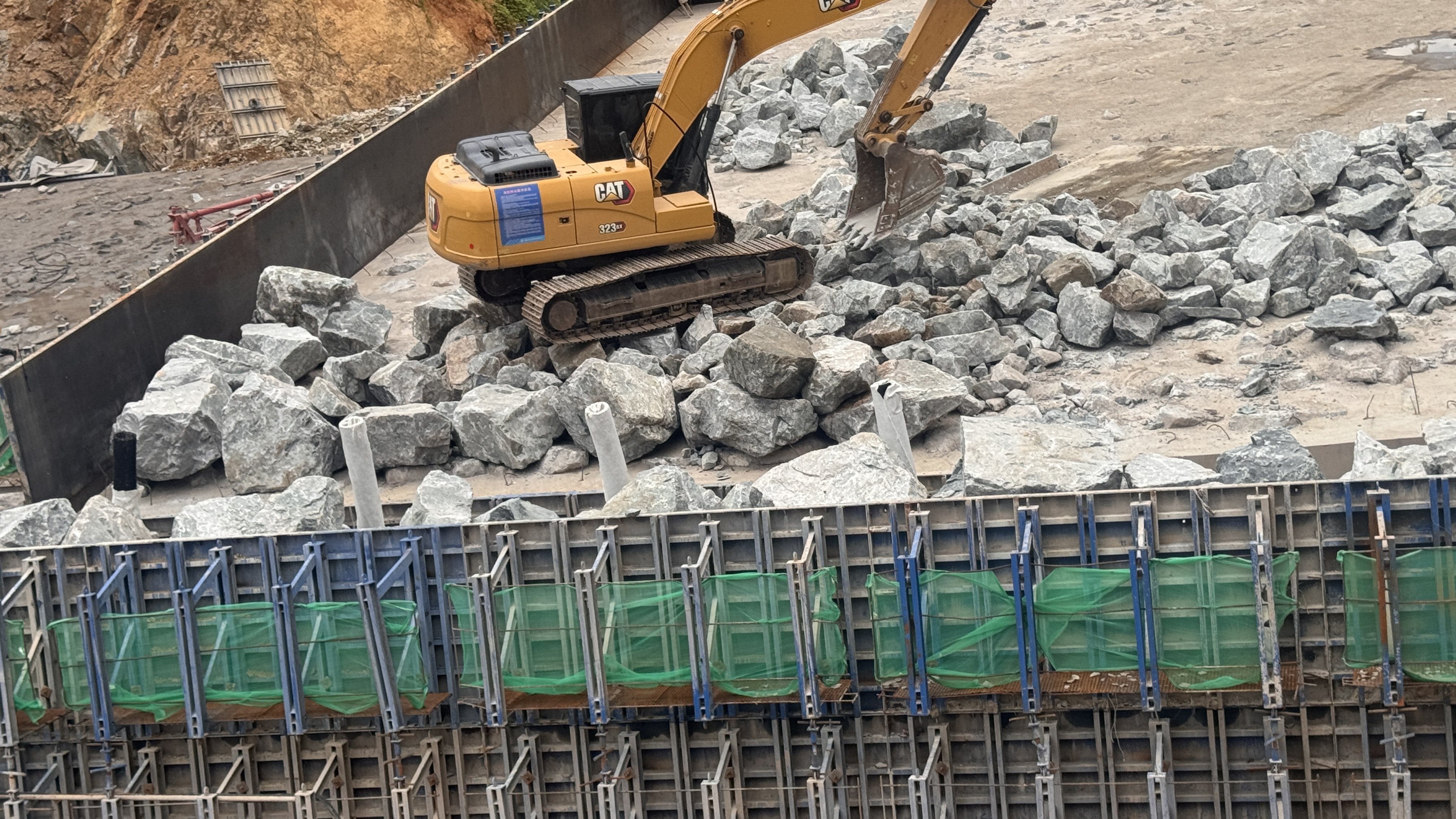 Excavator placing rocks